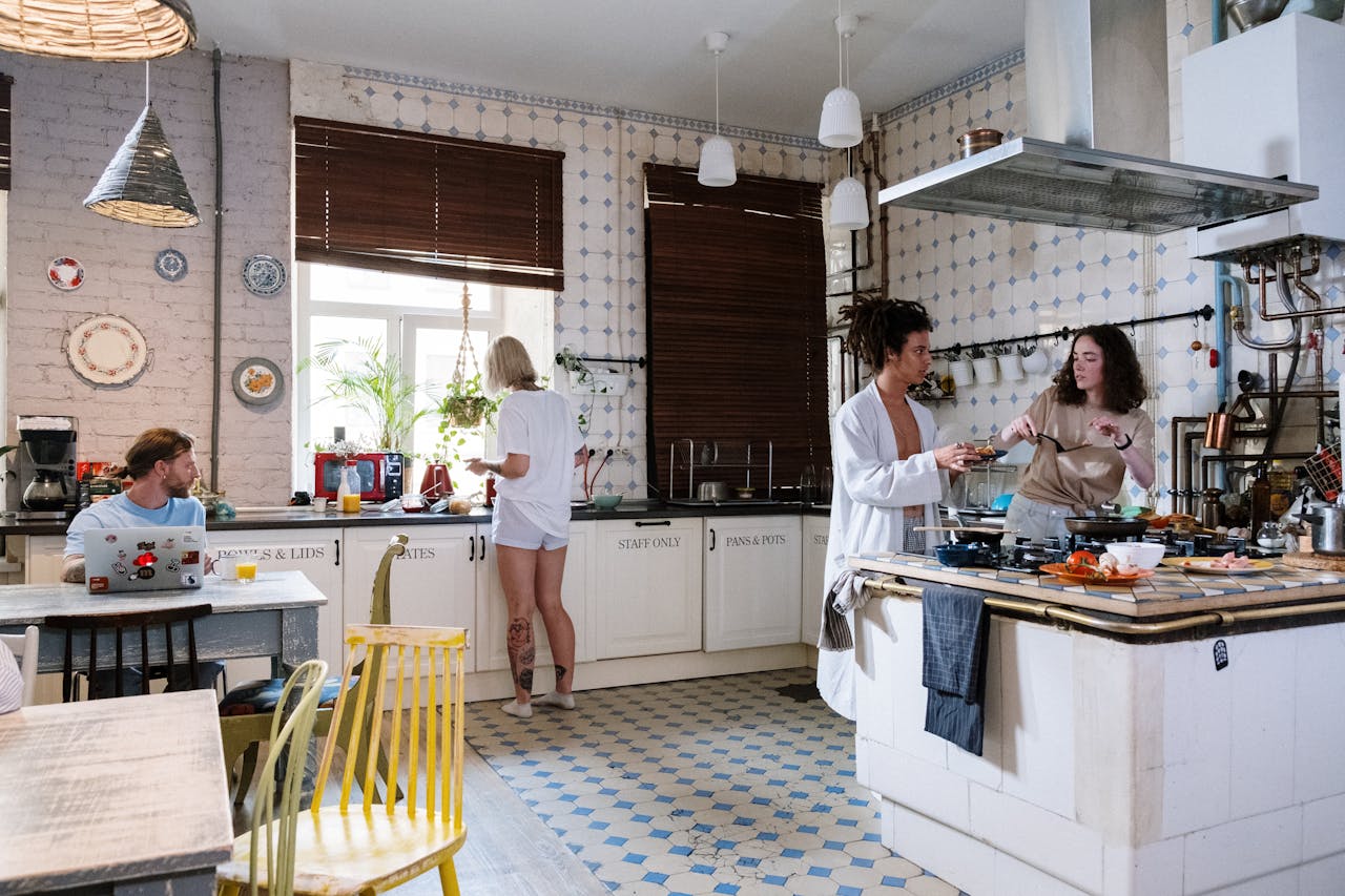 Friends enjoying a cozy day cooking together in a stylish kitchen setting.