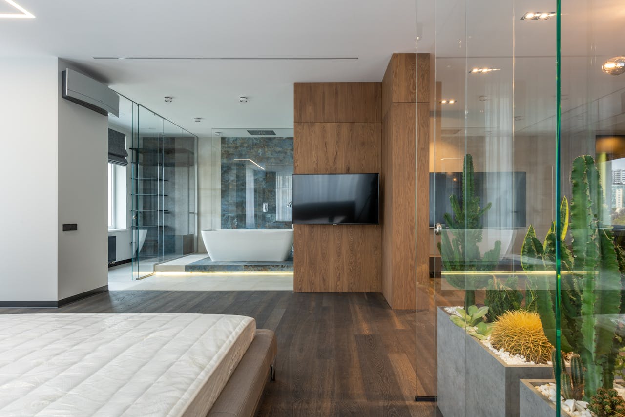 Interior of modern apartment with bedroom and bathroom with transparent glass walls
